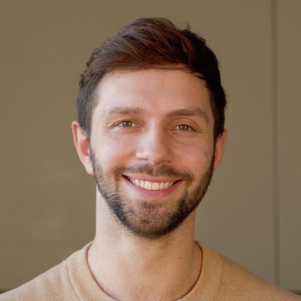 young man looking at camera in home office young man looking at camera e1645259789645.jpg